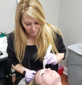 a client receiving microneedling services