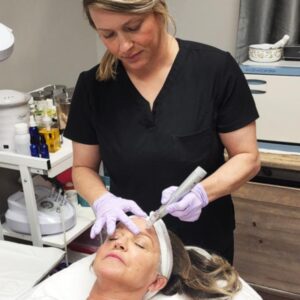 a client receiving a microneedling treatment from one of The Skin Clinics' estheticians