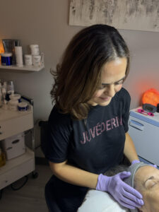 an esthetician at The Skin Clinics treating a client