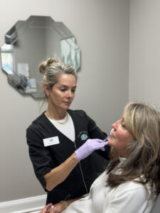 a nurse at The Skin Clinics treating a client